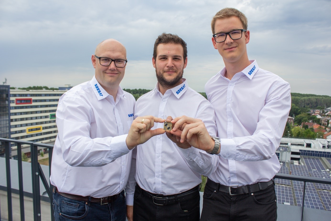 Gábor Marton, Martin Magda and Dániel Keresztény with the communication mini-module being prepared for space 